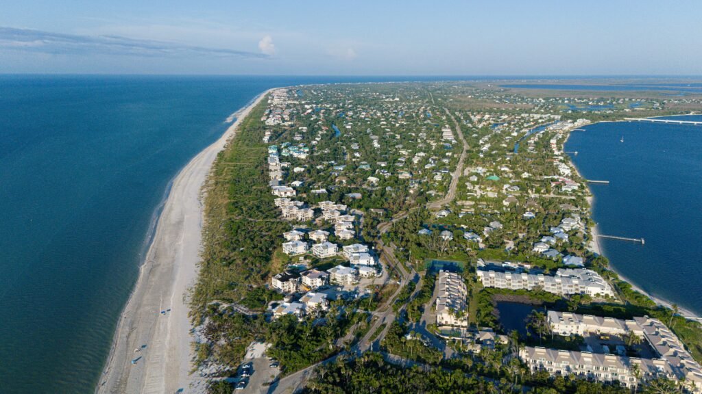pexels-photo-27858515-27858515 Stunning aerial photo of Sanibel Island, FL, showcasing the coastline and residential areas.